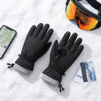 Gloves, phone and ski goggles in the snow